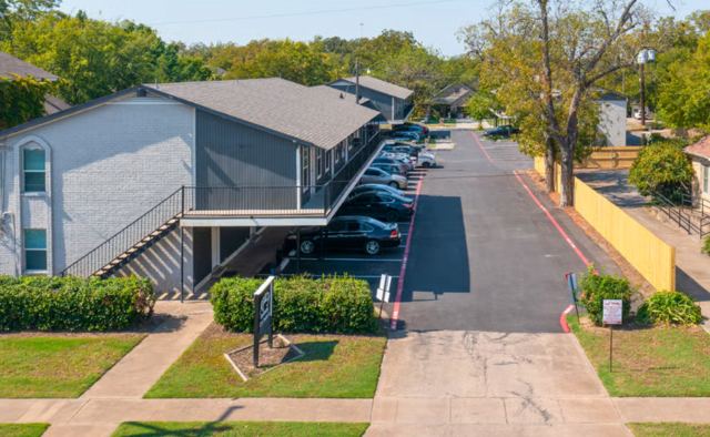 Elevated view of a Legacy Apartments building, sidewalk and parking lane